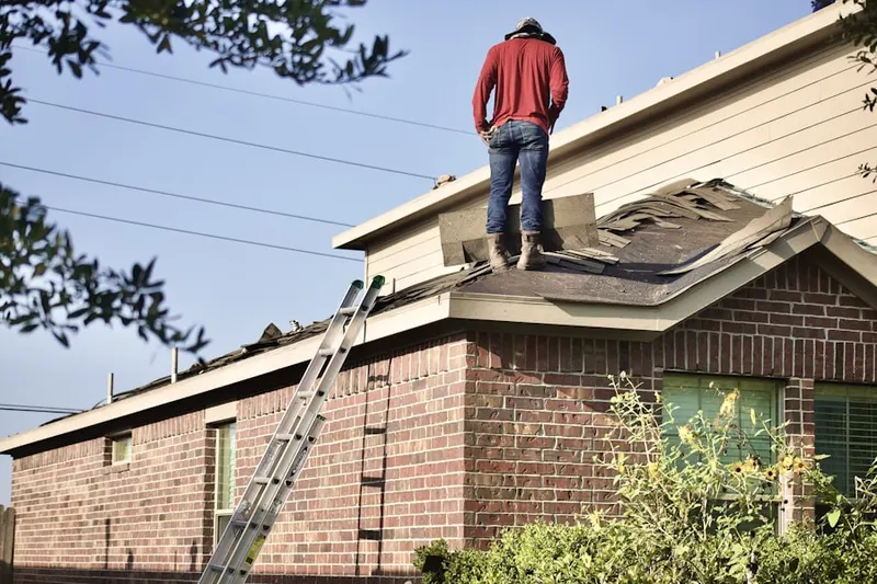 Professional roofer working on a residential roof in Hidden River